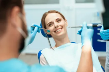 woman-sits-dental-chair-doctors-bowed