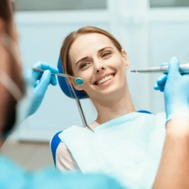 woman-sits-dental-chair-doctors-bowed