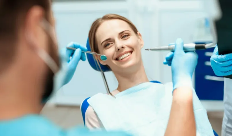 woman-sits-dental-chair-doctors-bowed